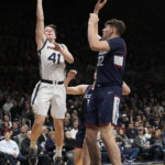 
              Butler guard Simas Lukosius (41) shoots in front of Connecticut center Donovan Clingan (32) in the first half of an NCAA college basketball game in Indianapolis, Saturday, Dec. 17, 2022. (AP Photo/AJ Mast)
            