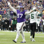 Minnesota Vikings defensive tackle Harrison Phillips (97) reacts in front of New York Jets quarterback Mike White (5) after a defensive stop during the second half of an NFL football game, Sunday, Dec. 4, 2022, in Minneapolis. (AP Photo/Bruce Kluckhohn)