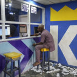 
              A man plays a World Cup betting game at a sports betting shop in Lagos, Nigeria, Monday, Dec. 5, 2022. Although sports betting is a global phenomenon and a legitimate business in many countries, the stakes are high on the continent of 1.3 billion people because of lax or non-existent regulation, poverty and widespread unemployment. (AP Photo/Sunday Alamba)
            