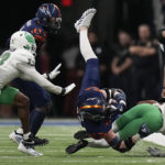
              UTSA tight end Dan Dishman, center, is upended by North Texas defensive back Quinn Whitlock (7) after a catch during the first half of an NCAA college football game for the Conference USA championship in San Antonio, Friday, Dec. 2, 2022. (AP Photo/Eric Gay)
            
