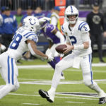 Indianapolis Colts quarterback Matt Ryan (2) looks to hand the ball off to running back Jonathan Taylor (28) during the first half of an NFL football game against the Minnesota Vikings, Saturday, Dec. 17, 2022, in Minneapolis. (AP Photo/Andy Clayton-King)