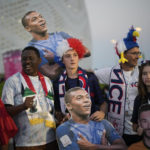 Soccer fans pose with pictures of France's Kylian Mbappe and France's goalkeeper Hugo Lloris ahead of the World Cup round of 16 soccer match between France and Poland, at the Al Thumama Stadium in Doha, Qatar, Sunday, Dec. 4, 2022. (AP Photo/Christophe Ena)
