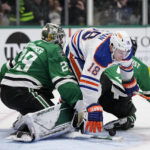Edmonton Oilers left wing Zach Hyman (18) collides with Dallas Stars' Jake Oettinger and Dallas Stars' Nils Lundkvist, right rear, on an attack in the second period of an NHL hockey game, Wednesday, Dec. 21, 2022, in Dallas. (AP Photo/Tony Gutierrez)