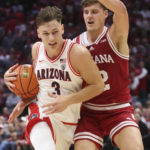 
              Arizona guard Pelle Larsson (3) drives against Indiana forward Miller Kopp (12) during the second half of an NCAA college basketball game Saturday, Dec. 10, 2022, in Las Vegas. (AP Photo/Chase Stevens)
            