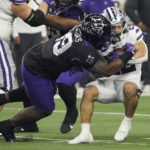 Kansas State running back Deuce Vaughn, right, is tackled by TCU linebacker Shadrach Banks (19) in the first half of the Big 12 Conference championship NCAA college football game, Saturday, Dec. 3, 2022, in Arlington, Texas. (AP Photo/LM Otero)
