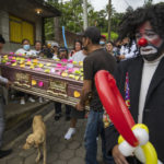 
              Relatives carry the coffin with the remains of professional clown Joselin "Chispita" Chacon Lobo, who disappeared for almost two months and was found buried in a clandestine site, before the start of her funeral procession in Amatitlan, Guatemala, on July 3, 2022. (AP Photo/Moises Castillo)
            
