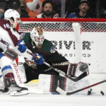 Arizona Coyotes goaltender Connor Ingram, right, makes a save on a shot by Colorado Avalanche center Alex Newhook (18) during the first period of an NHL hockey game in Tempe, Ariz., Tuesday, Dec. 27, 2022. (AP Photo/Ross D. Franklin)