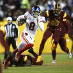 New York Giants quarterback Daniel Jones (8) runs the ball during the second half of an NFL football game against the Washington Commanders, Sunday, Dec. 18, 2022, in Landover, Md. (AP Photo/Nick Wass)