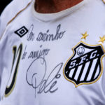 
              A fan wears a soccer jersey autographed by soccer legend Pele, outside the Vila Belmiro stadium in Santos, Brazil, Thursday, Dec. 29, 2022. Pele, the Brazilian king of soccer who won a record three World Cups and became one of the most commanding sports figures of the last century, died in Sao Paulo. He was 82. (AP Photo/Fabricio Costa)
            