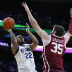 Villanova's Cam Whitmore, left, goes up for a shot against Oklahoma's Tanner Groves during the first half of an NCAA college basketball game, Saturday, Dec. 3, 2022, in Philadelphia. (AP Photo/Matt Slocum)