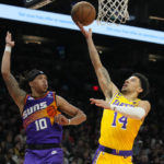 Los Angeles Lakers guard Scotty Pippen Jr., right, shoots over Phoenix Suns guard Damion Lee (10) during the first half of an NBA basketball game, Monday Dec. 19, 2022 in Phoenix.. (AP Photo/Rick Scuteri)