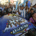 Argentina soccer fans celebrate their team's victory over Croatia at the end of the team's World Cup semifinal match in Qatar after watching it on TV in Buenos Aires, Argentina, Tuesday, Dec. 13, 2022. (AP Photo/Gustavo Garello)
