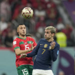 France's Antoine Griezmann, right, vies for the ball with Morocco's Selim Amallah during the World Cup semifinal soccer match between France and Morocco at the Al Bayt Stadium in Al Khor, Qatar, Wednesday, Dec. 14, 2022. (AP Photo/Christophe Ena)