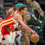 
              Atlanta Hawks guard Trae Young, front, drives into a foul by Charlotte Hornets forward Kai Jones, right, during the first half of an NBA basketball game Friday, Dec. 16, 2022, in Charlotte, N.C. (AP Photo/Rusty Jones)
            