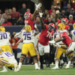 
              Georgia defenders Jalen Carter (88), Georgia Nazir Stackhouse (78), and Zion Logue (96) reach to block a field goal attempt by LSU place kicker Damian Ramos (34) in the first half of the Southeastern Conference Championship football game Saturday, Dec. 3, 2022 in Atlanta. Georgia returned the blocked kick for a touchdown. (AP Photo/John Bazemore)
            