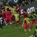 South Korea's team players celebrate after scoring their side's second goal during the World Cup group H soccer match between South Korea and Portugal, at the Education City Stadium in Al Rayyan, Qatar, Friday, Dec. 2, 2022. (AP Photo/Darko Bandic)