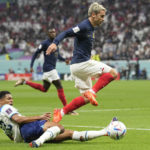 France's Antoine Griezmann, top, and England's Jude Bellingham battle for the ball during the World Cup quarterfinal soccer match between England and France, at the Al Bayt Stadium in Al Khor, Qatar, Saturday, Dec. 10, 2022. (AP Photo/Abbie Parr)