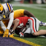 Georgia wide receiver Ladd McConkey (84) scores a touchdown in the first half of the Southeastern Conference championship NCAA college football game against LSU cornerback Jarrick Bernard-Converse (24) , Saturday, Dec. 3, 2022, in Atlanta. (AP Photo/Brynn Anderson)