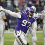 Minnesota Vikings defensive tackle Harrison Phillips (97) celebrates after a defensive stop during overtime in an NFL football game against the Indianapolis Colts, Saturday, Dec. 17, 2022, in Minneapolis. The Vikings won 39-36. (AP Photo/Andy Clayton-King)