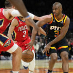 Phoenix Suns guard Chris Paul (3) dishes off against the New Orleans Pelicans during the second half of an NBA basketball game, Saturday, Dec. 17, 2022, in Phoenix. (AP Photo/Matt York)