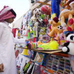 A child looks at the goods sold at a souvenir shop at the Souq Waqif Market in Doha, Qatar, Tuesday, Nov. 29, 2022. (AP Photo/Eugene Hoshiko)
