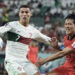 
              Portugal's Cristiano Ronaldo, left and South Korea's Kim Young-gwon vie for the ball during the World Cup group H soccer match between South Korea and Portugal, at the Education City Stadium in Al Rayyan , Qatar, Friday, Dec. 2, 2022. (AP Photo/Hassan Ammar)
            