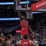 
              Chicago Bulls guard Ayo Dosunmu (12) attempts to rebound the ball during the second half of an NBA basketball game against the Atlanta Hawks on Wednesday, Dec. 21, 2022, in Atlanta. (AP Photo/Erik Rank)
            