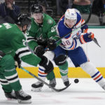 
              Edmonton Oilers left wing Zach Hyman (18) competes for control of the puck against Dallas Stars' Jani Hakanpaa and Esa Lindell in the second period of an NHL hockey game, Wednesday, Dec. 21, 2022, in Dallas. (AP Photo/Tony Gutierrez)
            