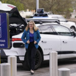
              Phoenix Mayor Kate Gallego arrives in a self-driving vehicle, Friday, Dec. 16, 2022, at the Sky Harbor International Airport Sky Train facility in Phoenix. Mayor Gallego announced Friday that Sky Harbor will be the first airport to have self-driving, ride-hailing service Waymo available. A test group has been using Waymo vehicles from the airport's sky train to downtown Phoenix since early November.(AP Photo/Matt York)
            