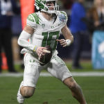 Oregon quarterback Bo Nix (10) looks to pass during the second half of the team's Holiday Bowl NCAA college football game against North Carolina on Wednesday, Dec. 28, 2022, in San Diego. (AP Photo/Denis Poroy)