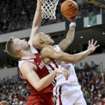 Arkansas guard Jordan Walsh drives past Bradley forward Rienk Mast to score during the first half of an NCAA college basketball game, Saturday, Dec. 17, 2022, in North Little Rock, Ark. (AP Photo/Michael Woods)