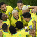 Teammates celebrate with Brazil's Neymar, center, who scored his side's second goal during the World Cup round of 16 soccer match between Brazil and South Korea, at the Education City Stadium in Al Rayyan, Qatar, Monday, Dec. 5, 2022. (AP Photo/Pavel Golovkin)