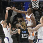 Phoenix Suns center Bismack Biyombo defends against Memphis Grizzlies forward Jaren Jackson Jr. in the first half of an NBA basketball game, Tuesday, Dec. 27, 2022, in Memphis, Tenn. (AP Photo/Brandon Dill)