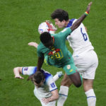 
              England's Harry Maguire, right, and Senegal's Bamba Dieng vie for the ball during the World Cup round of 16 soccer match between England and Senegal, at the Al Bayt Stadium in Al Khor, Qatar, Sunday, Dec. 4, 2022. (AP Photo/Darko Bandic)
            