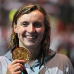
              FILE - Gold medalist Katie Ledecky of the United States poses with her medal after the Women 800m Freestyle final at the 19th FINA World Championships in Budapest, Hungary, Friday, June 24, 2022. The American swimmer turned in another stellar performance at the world championships, set a pair of world records, and capped 2022 as The Associated Press Female Athlete of the Year by a panel of 40 sports writers and editors from news outlets across the country. (AP Photo/Petr David Josek, File)
            