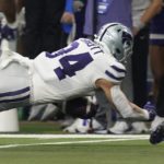 Kansas State tight end Ben Sinnott (34) dives into the end zone for a touchdown in the first half of the Big 12 Conference championship NCAA college football game against TCU, Saturday, Dec. 3, 2022, in Arlington, Texas. (AP Photo/LM Otero)