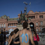 
              Argentina soccer fans stand outside the Casa Rosada presidential palace, after waiting for hours for a homecoming parade for the players who won the World Cup title, in Buenos Aires, Argentina, Tuesday, Dec. 20, 2022. A parade to celebrate the Argentine World Cup champions was abruptly cut short Tuesday as millions of people poured onto thoroughfares, highways and overpasses in a chaotic attempt to catch a glimpse of the national team. (AP Photo/Rodrigo Abd)
            