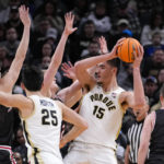 
              Purdue center Zach Edey (15) is surrounded by Davidson players in the second half of an NCAA college basketball game in Indianapolis, Saturday, Dec. 17, 2022. Purdue defeated Davidson 69-61. (AP Photo/Michael Conroy)
            