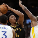 Toronto Raptors forward Scottie Barnes (4) looks to shoot while under pressure from Golden State Warriors center Kevon Looney (5) and Jordan Poole (3) during first-half NBA basketball game action in Toronto, Sunday, Dec. 18, 2022. (Frank Gunn/The Canadian Press via AP)