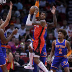 
              Houston Rockets guard Kevin Porter Jr., front center, pulls down a rebound in the middle of New York Knicks players, from left to right, New York Mitchell Robinson (23), Quentin Grimes, Julius Randle and Miles McBride (2) during the first half of an NBA basketball game Saturday, Dec. 31, 2022, in Houston. (AP Photo/Michael Wyke)
            