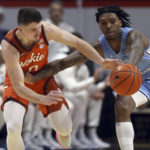 
              North Carolina's Caleb Love, right, steals a pass intended for Virginia Tech's Hunter Cattoor in the first half of an NCAA college basketball game in Blacksburg Va., Sunday Dec. 4, 2022. (Matt Gentry/The Roanoke Times via AP)
            