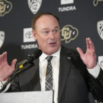 Colorado athletic director Rick George introduces Deion Sanders as the new head football coach at the University of Colorado during a news conference Sunday, Dec. 4, 2022, in Boulder, Colo. Sanders left Jackson State University after three seasons at the helm of the school's football team. (AP Photo/David Zalubowski)