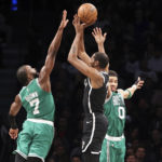 
              Brooklyn Nets forward Kevin Durant, center, shoots a 3-point basket against Boston Celtics guard Jaylen Brown (7) and forward Jayson Tatum (0) during the first half of an NBA basketball game, Sunday, Dec. 4, 2022, in New York. (AP Photo/Jessie Alcheh)
            