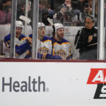 Three Los Angeles Kings Gabriel Vilardi, left, Trevor Moore, middle, and Brendan Lemieux, right, sit in the penalty box in the first period during an NHL hockey game against the Arizona Coyotes, Friday, Dec. 23, 2022, in Tempe, Ariz. (AP Photo/Darryl Webb)