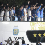 
              Players from the Argentine soccer team wave from the bus that takes them to Argentina Soccer Association, where they will spend the night after landing at Ezeiza airport on the outskirts of Buenos Aires, Argentina, Tuesday, Dec. 20, 2022. (AP Photo/Gustavo Garello)
            