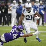 Indianapolis Colts running back Zack Moss (21) runs from Minnesota Vikings safety Camryn Bynum (24) during the first half of an NFL football game, Saturday, Dec. 17, 2022, in Minneapolis. (AP Photo/Andy Clayton-King)