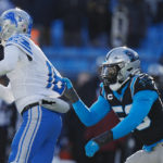 Detroit Lions quarterback Jared Goff looks to pass under pressure from Carolina Panthers defensive end Brian Burns during the second half of an NFL football game between the Carolina Panthers and the Detroit Lions on Saturday, Dec. 24, 2022, in Charlotte, N.C. (AP Photo/Rusty Jones)