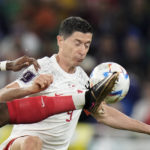
              France's Aurelien Tchouameni, left, fights for the ball with Poland's Robert Lewandowski during the World Cup round of 16 soccer match between France and Poland, at the Al Thumama Stadium in Doha, Qatar, Sunday, Dec. 4, 2022. (AP Photo/Moises Castillo)
            