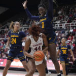 Stanford forward Kiki Iriafen (44) is fouled by California forward Ugonne Onyiah during the first half of an NCAA college basketball game in Stanford, Calif., Friday, Dec. 23, 2022. (AP Photo/Godofredo A. Vásquez)