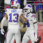 Buffalo Bills wide receiver Stefon Diggs (14) is congratulated by Gabe Davis (13) after his touchdown against the New England Patriots during the first half of an NFL football game, Thursday, Dec. 1, 2022, in Foxborough, Mass. (AP Photo/Steven Senne)